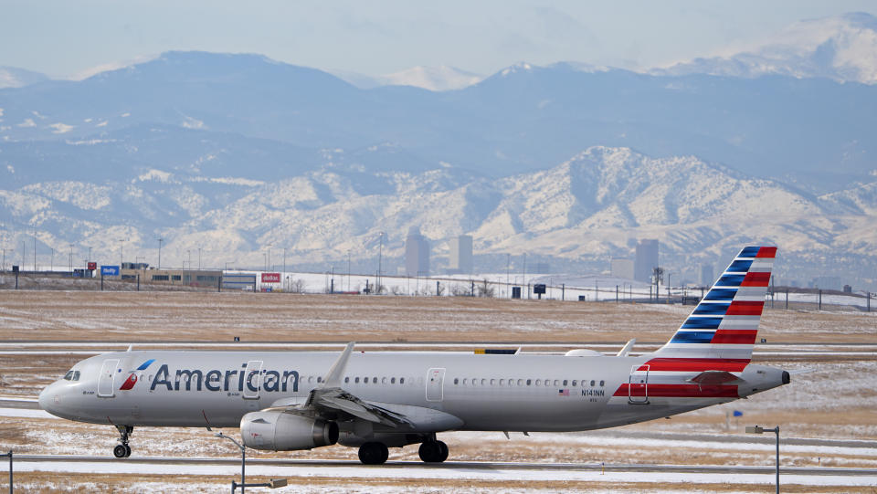 FILE - An American Airlines jet descends a runway at Denver International Airport, Jan. 16, 2024, in Denver.  American Airlines is reducing some of its financial forecasts for the second quarter and announced the departure of its chief commercial officer.  (AP Photo/David Zalubowski, File)