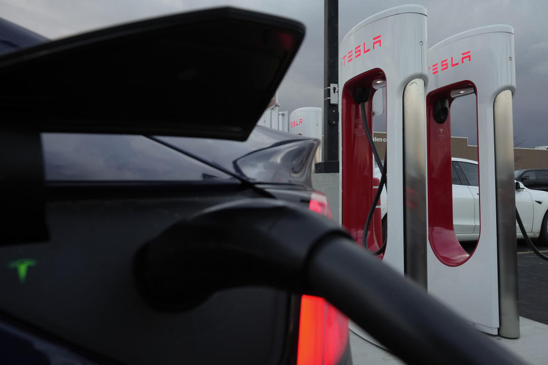 FILE - A vehicle charges at a Tesla Supercharger station in Detroit, Nov. 16, 2022. Elon Musk's decision to fire the department responsible for Tesla's electric vehicle charging network has sparked concerns in the auto industry about plans to open the chargers for EVs made by other automakers.  Several leaders of Tesla's Supercharger team posted messages on social media saying they were informed on Monday, April 29, 2024, that the entire group of about 500 people had been eliminated by CEO Musk.  (AP Photo/Paul Sancya, File)