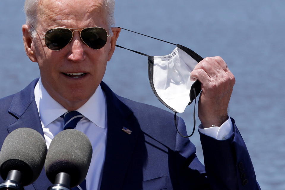 US President Joe Biden removes his protective mask to deliver remarks about his American Jobs Plan near the Calcasieu River Bridge in Lake Charles, Louisiana, US, May 6, 2021. REUTERS/Jonathan Ernst