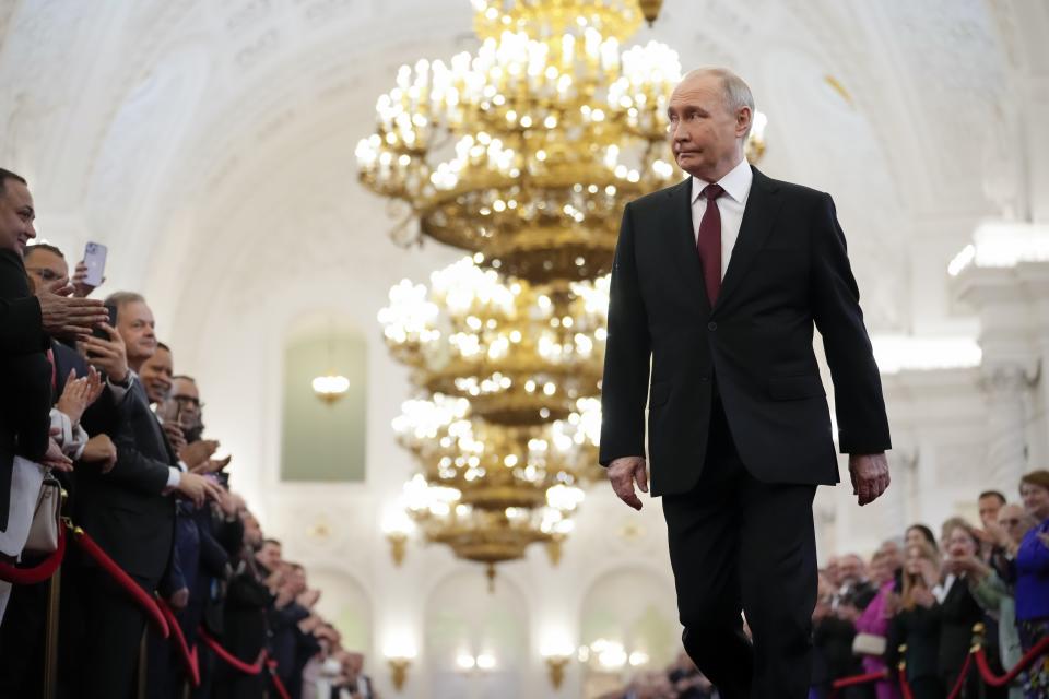 Vladimir Putin walks to take the oath as Russian president during an inauguration ceremony in the St. George Hall of the Grand Kremlin Palace in Moscow, Russia, Tuesday, May 7, 2024. Putin began his fifth term in office in a glittering Kremlin inauguration on Tuesday, embarking on another six years as Russia's leader after destroying his political opponents, launching a devastating war in Ukraine and concentrating all power in his hands.  (AP Photo/Alexander Zemlianichenko, Swimming Pool)