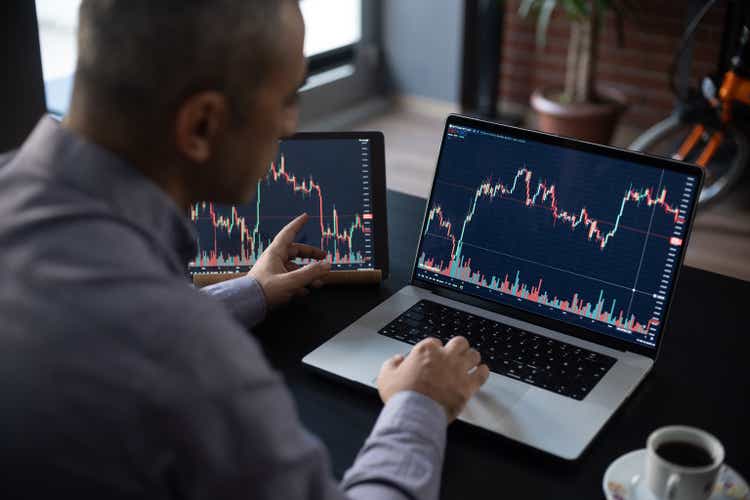 Man Checking His Stock Market Exchange Investment Using His Laptop Computer.