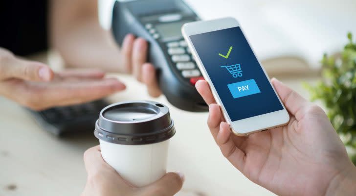 A conceptual image of mobile payment with a smartphone for a cup of coffee.