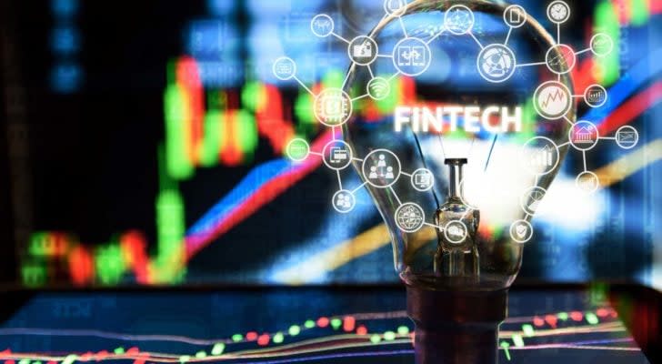 Light bulb on tablet and stock graph and business technology icon with abstract electronic circuit background.  the best fintech stocks to buy.  The best Fintech stocks to buy