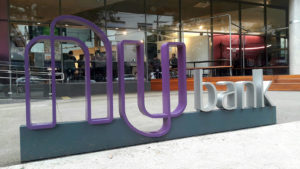 A Nubank sign outside an office building.