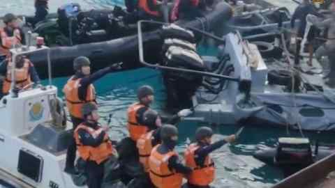 A frame grab from a video released by the Philippine military shows Chinese coast guard ships colliding with Philippine navy inflatable boats