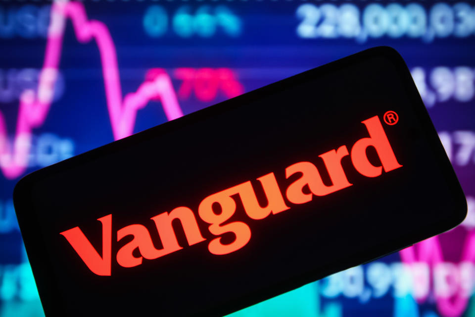 UKRAINE - 12/30/2021: In this photo illustration, the Vanguard Group Inc. logo is seen on a smartphone screen and a stock market line graph is seen in the background.  (Photo illustration by Pavlo Gonchar/SOPA Images/LightRocket via Getty Images)