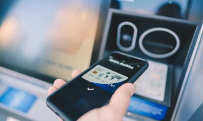 Man at the ATM withdrawing money with smartphone