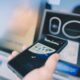 Man at the ATM withdrawing money with smartphone