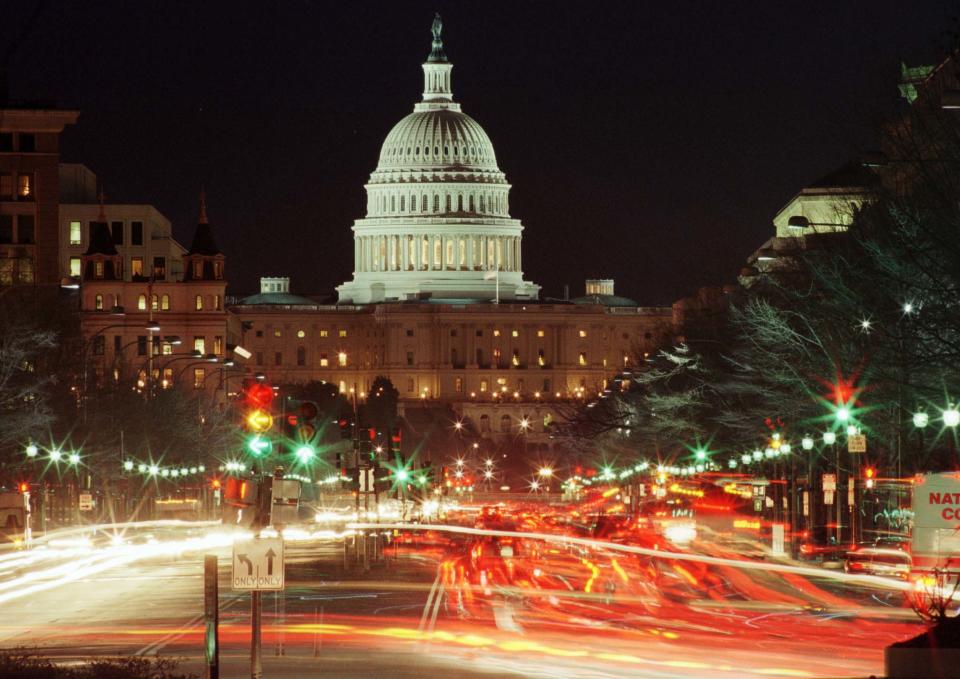 Traffic flows along Pennsylvania Avenue toward the U.S. Capitol after dark on Dec. 15 as the House of Representatives prepares to convene Dec. 17 to debate the impeachment of President Bill Clinton. A House vote to impeach would send the case to the Senate for a trial. TB/RC/CLH/