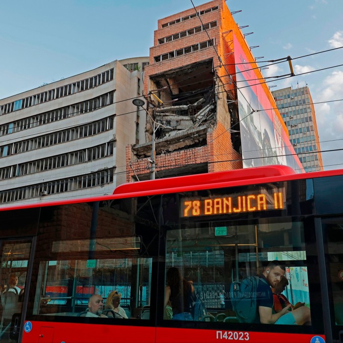 A bus passes the ruined building that once housed Yugoslavia’s Ministry of Defence 